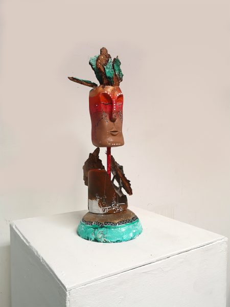 Lateral view of 'L'etica del fuoco'. clay-based mixedmedia Sculpture inspired by the Natural element fire. Colored with sprays and acrylics. Here in the studio of the artist.